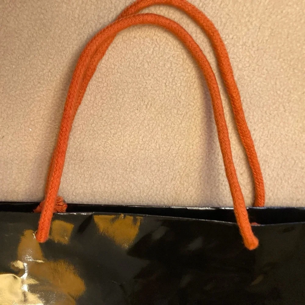 Guy Laroche Paris,black gloss glazed paper branded shopping tote,orange handles